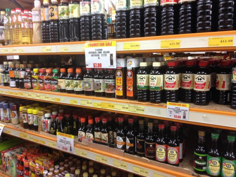 Shop shelves with 4 rows of dark soy sauce bottles.jpg